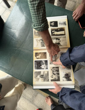 sharing old family photos during an unexpected discovery of ancestors in Calabria