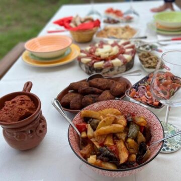 Outdoor countryside dining table with traditional Calabrian dishes during a four day guided tour in Tropea