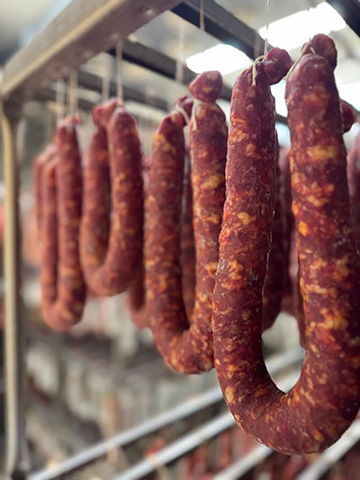Calabrian salami hanging to cure at a local producer
