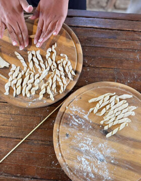 Guests preparing fresh pasta in a traditional cooking class in Calabria