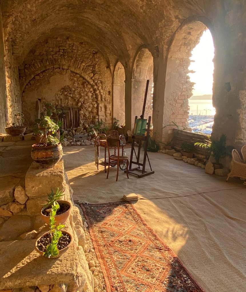 Painting easel on a historic stone terrace overlooking the Calabria coastline, Art and Craft Tour Tropea Italy