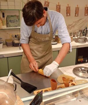 Hands preparing fresh gelato during a traditional gelato making class